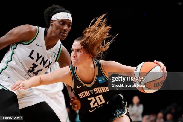 Guard Sabrina Ionescu of the New York Liberty dribbles as center Sylvia Fowles of the Minnesota Lynx defends during the second half at Barclays...
