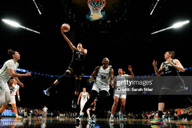 Guard Rebecca Allen of the New York Liberty goes to the basket as center Sylvia Fowles of the Minnesota Lynx defends during the game at Barclays...