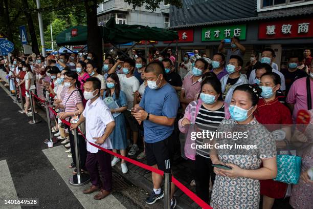 Parents wait to pick up students outside a national college entrance exam venue on June 7, 2022 in Wuhan, Hubei province, China. China's annual...