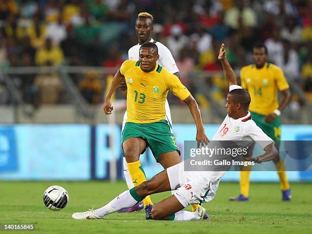 Kagisho Dikgacoi of South Africa is tackled by Ricardo Faty of Senegal during the International Friendly match between South Africa and Senegal at...