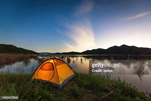 camp tent by the lake under the starry sky - dome stock pictures, royalty-free photos & images