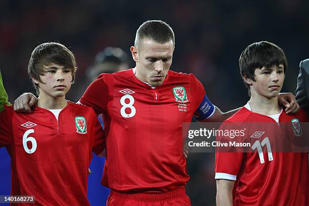 Craig Bellamy of Wales is seen with Edward and Thomas Speed during the national anthem during the Gary Speed Memorial International Match between...