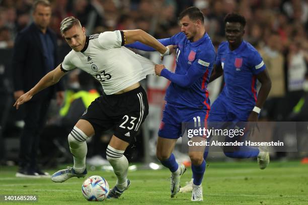 Mason Mount of England is challenged by Nico Schlotterbeck of Germany during the UEFA Nations League League A Group 3 match between Germany and...