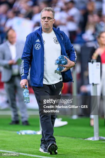 Team doctor Dr. Tim Meyer of Germany brings bottles of water for the players prior the UEFA Nations League League A Group 3 match between Germany and...