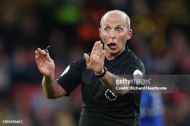 Referee Mike Dean gives instructions during the Premier League match between Watford and Everton at Vicarage Road on May 11, 2022 in Watford, England.