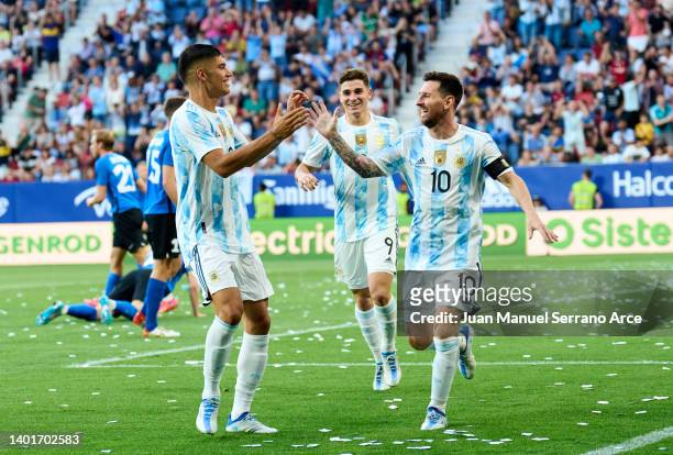 Lionel Messi of Argentina celebrates with his teammates Carlos Joaquin Correa of Argentina after scoring his team's third goal during the...