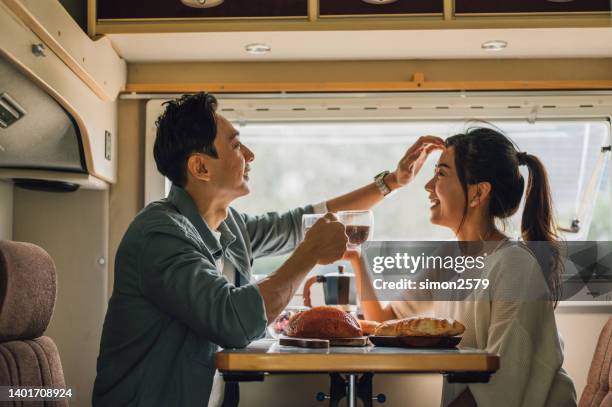 asian chinese couple enjoy their breakfast and coffee at the camper - asian couple car stock pictures, royalty-free photos & images