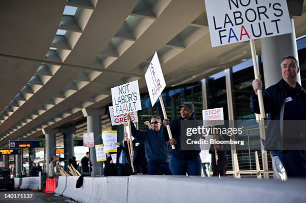 Members of Transportation Workers Union Local 521 demonstrate outside American Airlines Terminal 3 at O'Hare International Airport in Chicago,...