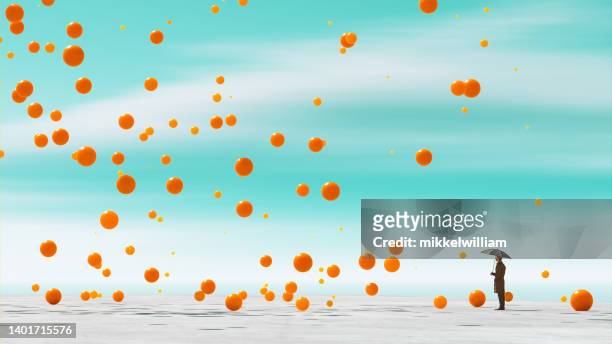 orange balls fall from the sky and bouce of the ground - wait until spring stockfoto's en -beelden