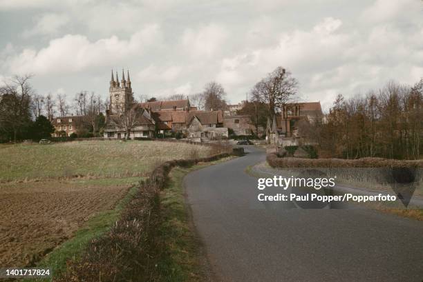 View along Rogues Hill towards the village of Penshurst near Sevenoaks in Kent, England circa 1960. The tower of St John the Baptish parish church is...