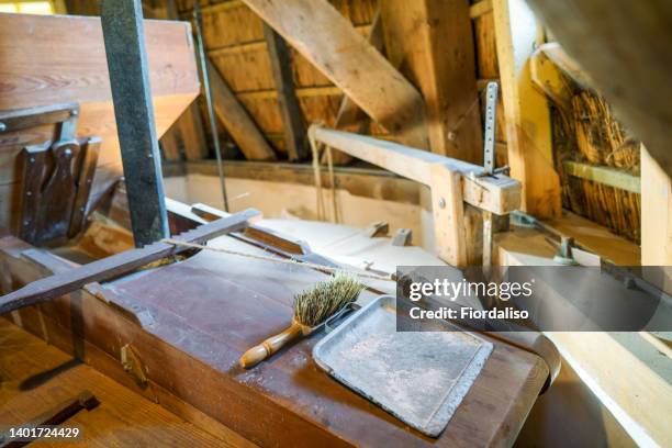 interior inside an old wooden mill. tools for work. - wasserrad stock-fotos und bilder