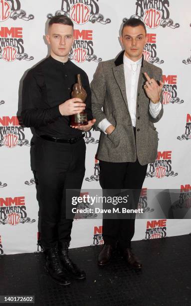 Adam Anderson and Theo Hutchcraft of Hurts pose in front of the winners boards with the award for Best Video at the NME Awards 2012 held at the...