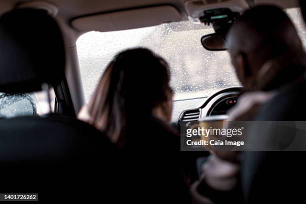 couple with coffee in car - auto von hinten winter stock-fotos und bilder