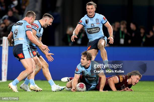Cameron Murray of the Blues celebrates with team mates after scoring a try during game one of the 2022 State of Origin series between the New South...