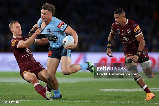 Jack Wighton of the Blues is tackled by Daly Cherry-Evans of the Maroons during game one of the 2022 State of Origin series between the New South...