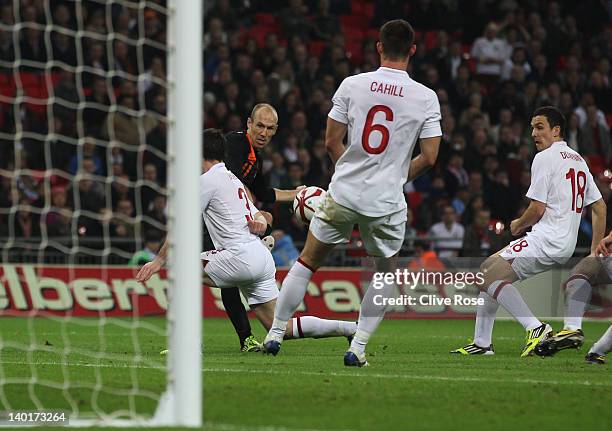 Arjen Robben of Netherlands scores his team's third goal past Leighton Baines, Gary Cahill and Stewart Downing of England during the international...