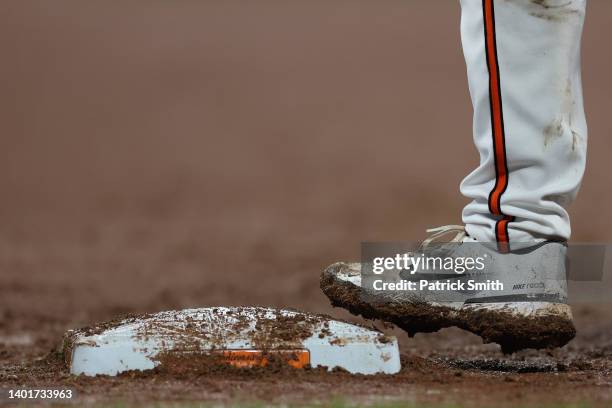 Muddy baseball cleat and muddy first base are seen at Oriole Park at Camden Yards on June 07, 2022 in Baltimore, Maryland.