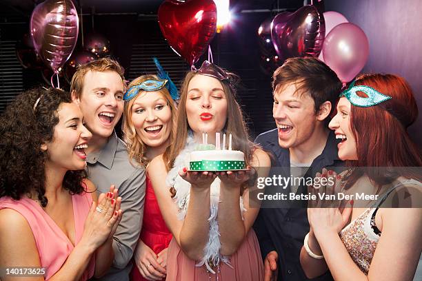 woman blowing candles of birthday cake. - woman birthday stock pictures, royalty-free photos & images