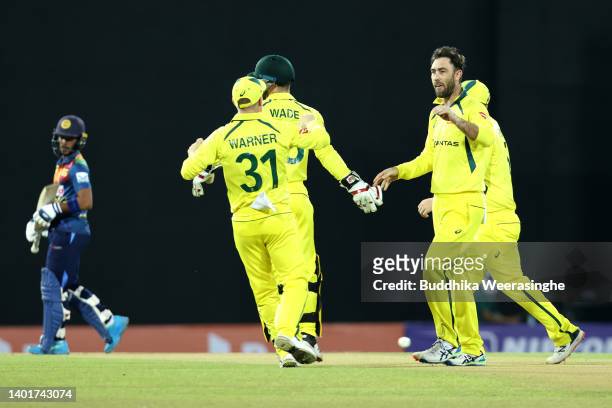 Glenn Maxwell of Australia celebrates with his teammates after taking the wicket of Pathum Nissanka of Sri Lanka during the 2nd match in the T20...