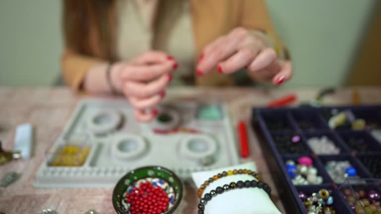 https://media.gettyimages.com/id/1401752030/video/making-jewelry-with-beads.jpg?b=1&s=640x640&k=20&c=dIRHQe5vLZtelvectSDf79qMlz0GzR3H0mYb3rf9A8E=