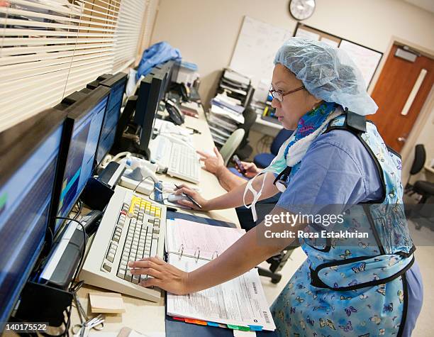 nurse in xray protective clothing - nurse working stock pictures, royalty-free photos & images