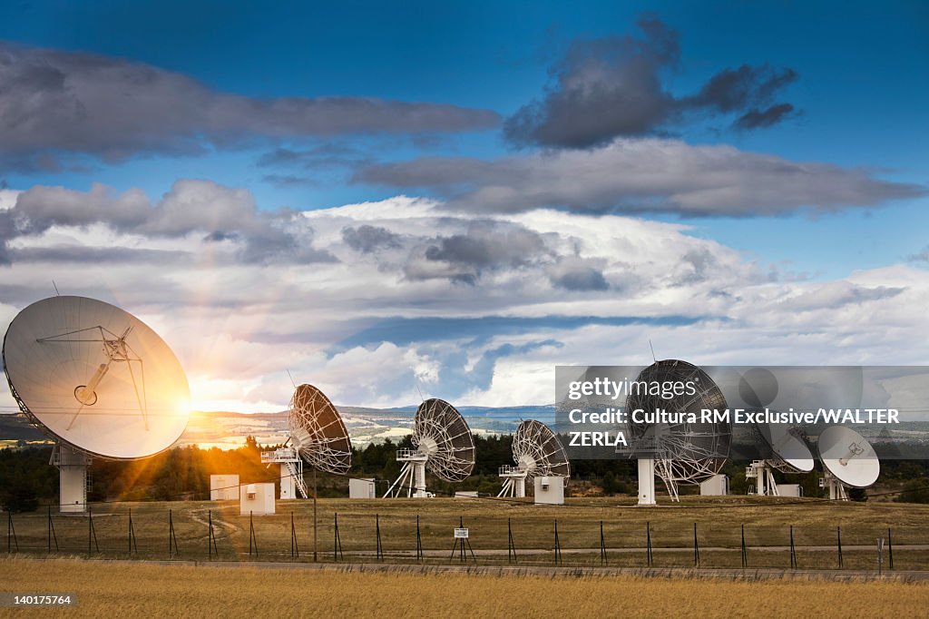 Satellite dishes in rural landscape