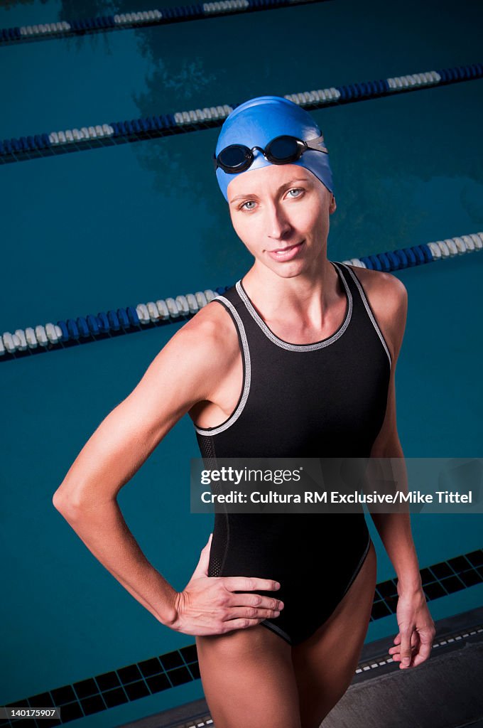 Swimmer standing at edge of pool