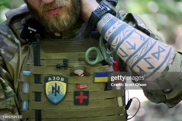 Ukrainian army field medic Oleksii sits in his base camp in a wooded area about 25 kilometers from the front where he rotates in and out, treating...