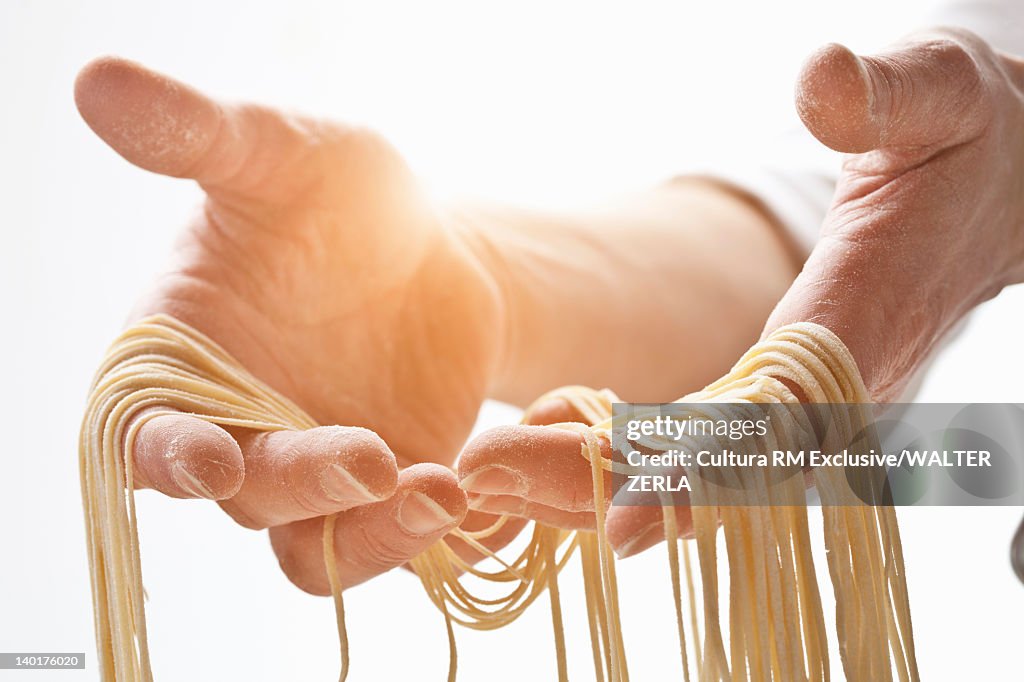 Chef holding fresh pasta dough