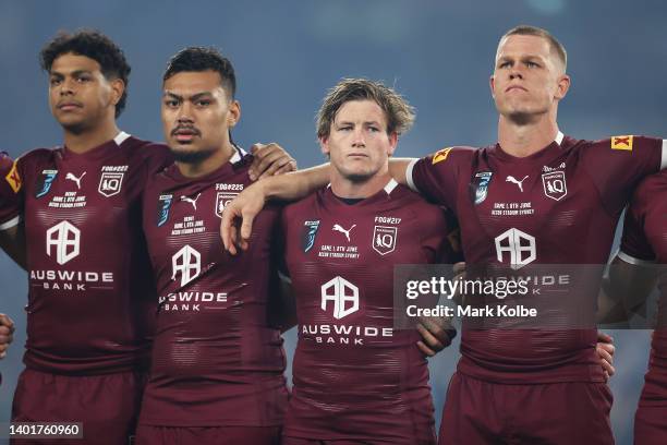 Selwyn Cobbo, Jeremiah Nanai, Harry Grant and Lindsay Collins of the Maroons line up for the national anthem before game one of the 2022 State of...