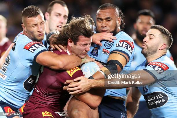 Patrick Carrigan of the Maroons tis tackled during game one of the 2022 State of Origin series between the New South Wales Blues and the Queensland...