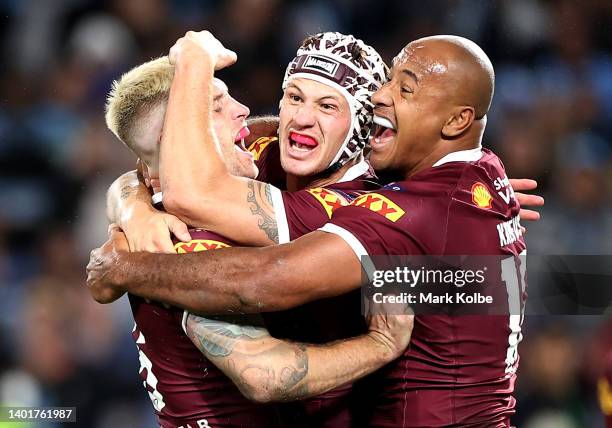 Cameron Munster, Kalyn Ponga and Felise Kaufusi of the Maroons celebrate victory at full-time during game one of the 2022 State of Origin series...