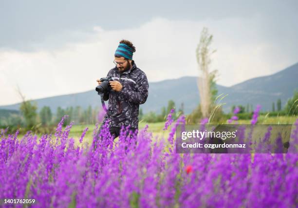 male photographer taking landscape pictures on the field in nature - purple bandanna stock pictures, royalty-free photos & images