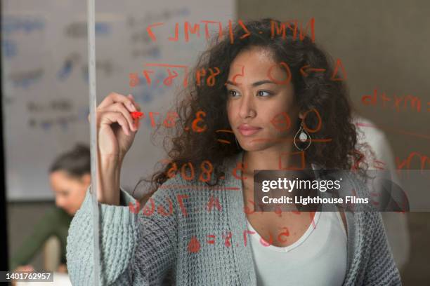 businesswoman writes on window during meeting - writing a will stock pictures, royalty-free photos & images