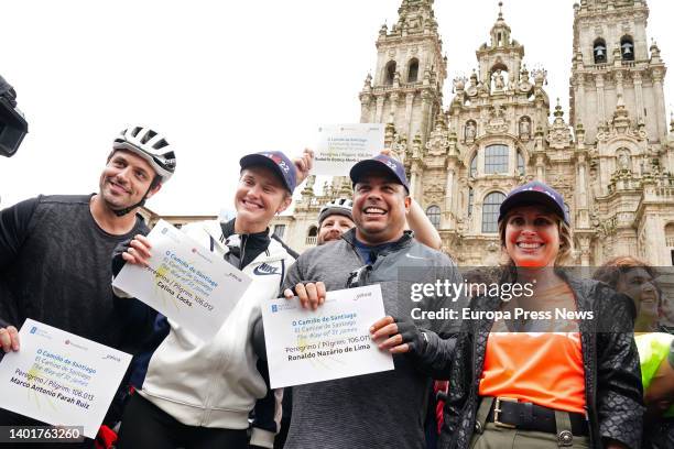 Former Real Valladolid footballer and president Ronaldo Nazario and his partner Celina Locks pose with the pilgrim's diploma on their arrival at the...