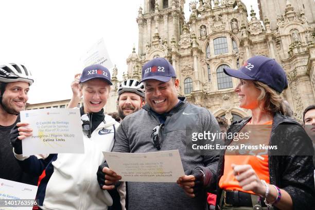 Former Real Valladolid footballer and president Ronaldo Nazario and his partner Celina Locks pose with the pilgrim's diploma on their arrival at the...