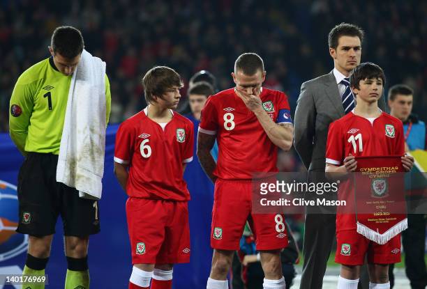 Lewis Price,Craig Bellamy and Aaron Ramsey of Wales are seen with Edward and Thomas Speed during the national anthem during the Gary Speed Memorial...