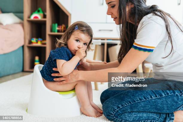 potty training - girls peeing stock pictures, royalty-free photos & images