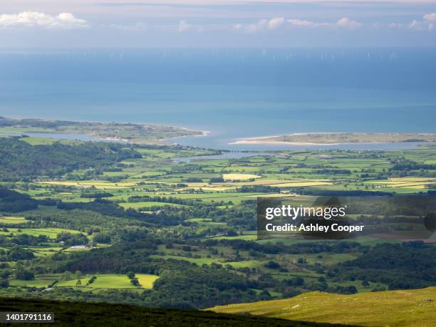 looking towards ravenglass and the cumbrian coast from seatallan, lake district, uk with the walney offshoire wind farm in the distance. - cumbrian coast stock pictures, royalty-free photos & images