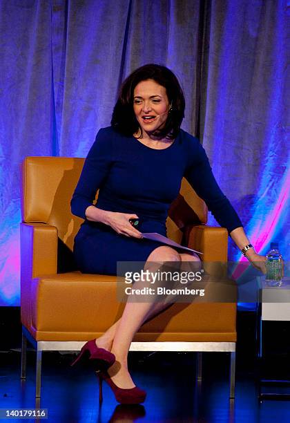 Sheryl Sandberg, chief operating officer of Facebook Inc., speaks with Kenneth Chenault, chief executive officer of American Express Co., unseen, at...