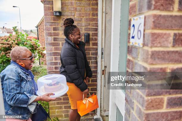 two women arriving at family and friends house - guest door ストックフォトと画像