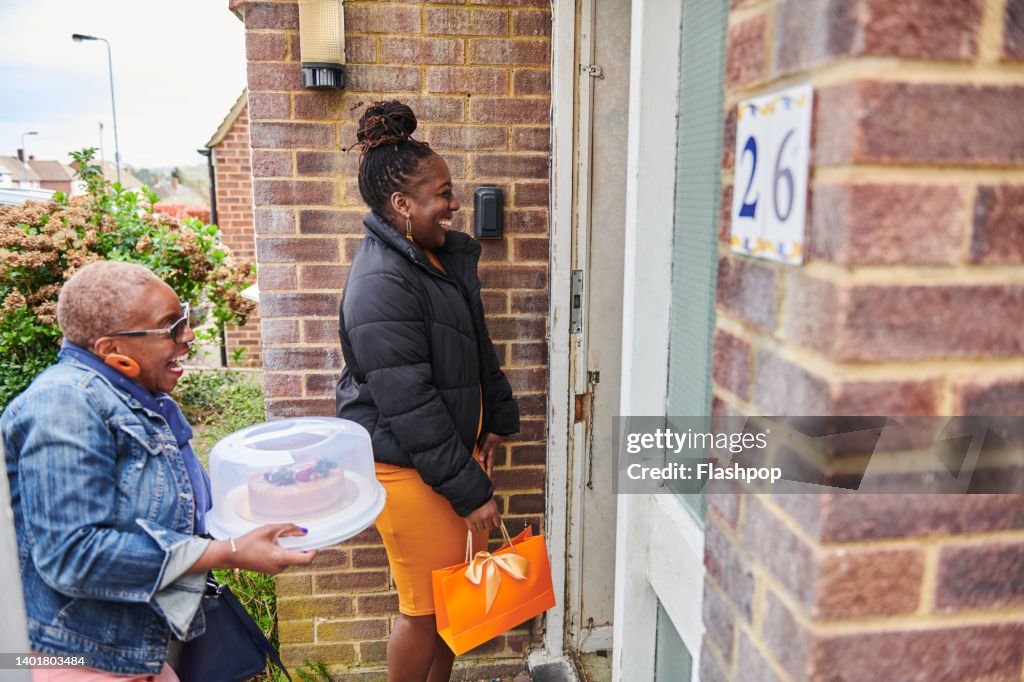Two women arriving at family and friends house