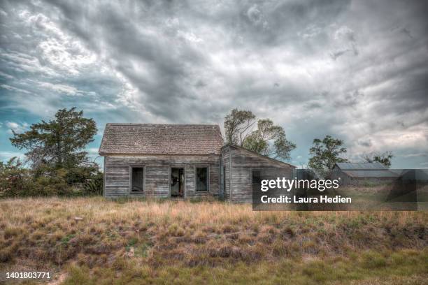 old abandoned structures on the great plains with incoming storms - great plains stock pictures, royalty-free photos & images