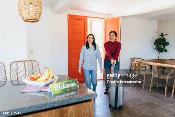 lesbian couple arrive at vacation rental - summer home stock pictures, royalty-free photos & images