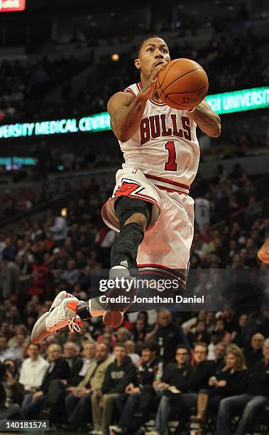 Derrick Rose of the Chicago Bulls leaps through the air to the basket against the New Orleans Hornets at the United Center on February 28, 2012 in...