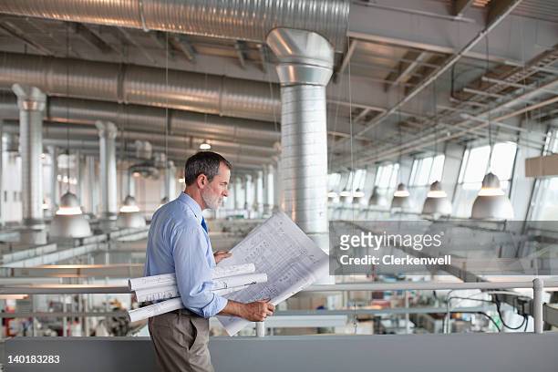 architect viewing blueprints - architect stock pictures, royalty-free photos & images