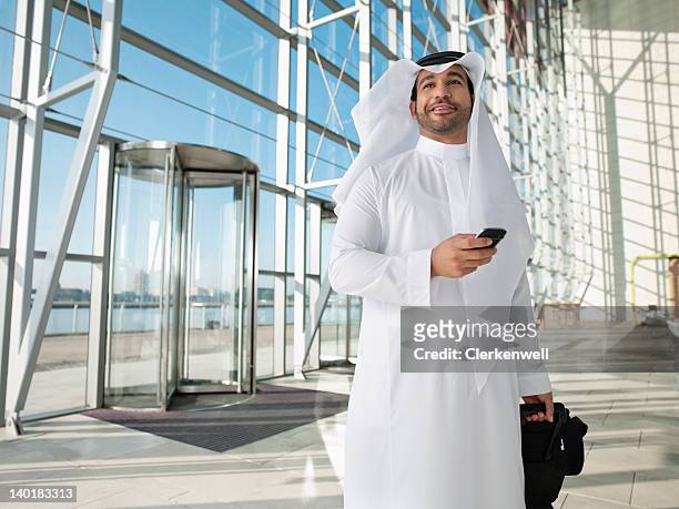 zuversichtlich mann im keffiyeh mit koffer - arab phone stock-fotos und bilder