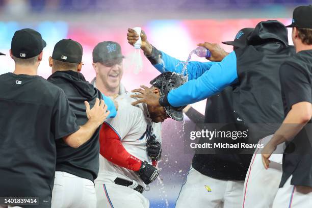 Jesus Aguilar of the Miami Marlins celebrates with teammates after hitting a walk-off single during the tenth inning against the Washington Nationals...