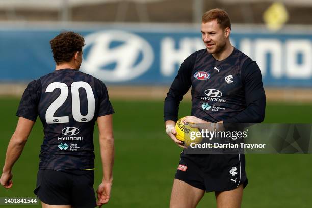 Charlie Curnow and Harry McKay of the Blues share a conversation during a Carlton Blues AFL training session at Ikon Park on June 09, 2022 in...