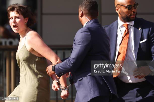 Protester is led away in handcuffs after approaching a motorcade during the Ninth Summit of the Americas on June 08, 2022 in Los Angeles, California....